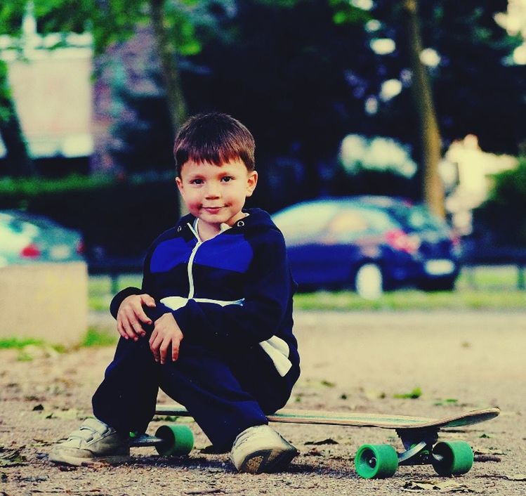 childhood, elementary age, boys, lifestyles, leisure activity, casual clothing, person, full length, innocence, focus on foreground, cute, girls, playing, sitting, park - man made space, playful, happiness, front view