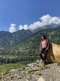 Low section of man standing on mountain