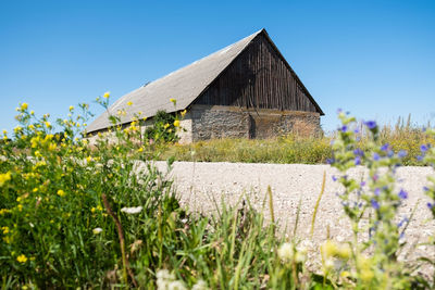 House on field against clear sky