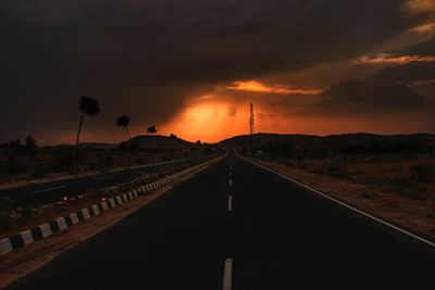 Railroad tracks against sky during sunset