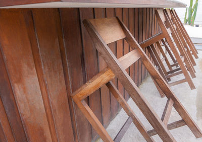 High angle view of wooden chairs on table