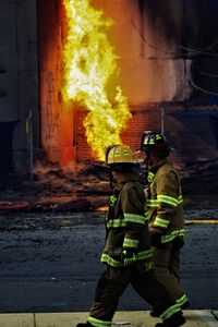 Fighters walking by fire on footpath