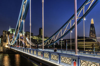 Bridge over river in city against sky