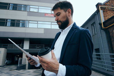 Side view of businessman using mobile phone