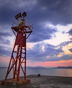 Low angle view of tower against sky during sunset
