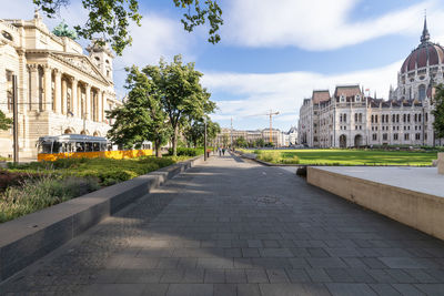 Hungarian parliament building, yellow vintage tram passing by at kossuth square, budapest, hungary.