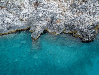 High angle view of rocks in sea