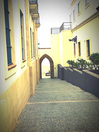 Empty alley amidst buildings in city