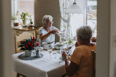 Senior women having meal together at dining table