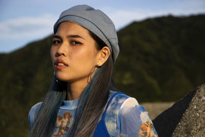Portrait of beautiful young woman looking away