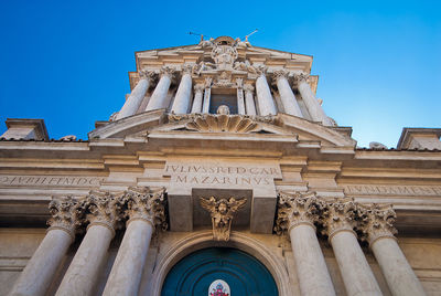 Low angle view of historic building against blue sky