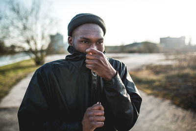 Portrait of young woman standing outdoors