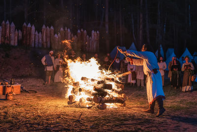 Group of people on bonfire at night