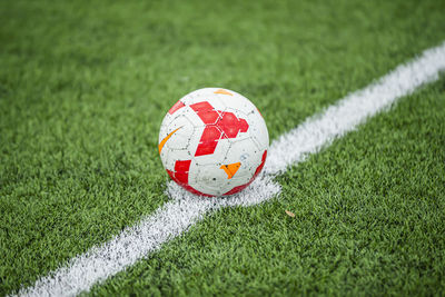 Close-up of soccer ball on field