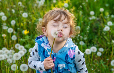 Portrait of cute girl blowing bubbles