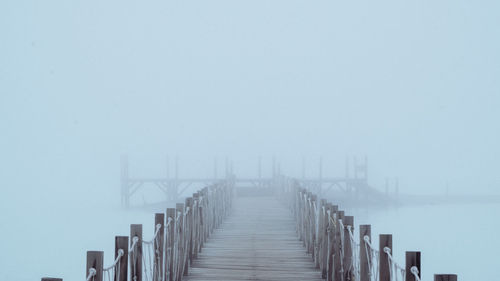 Pier over sea against clear sky