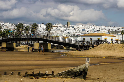 Bridge over cityscape against sky