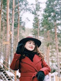 Portrait of a young woman standing in snow