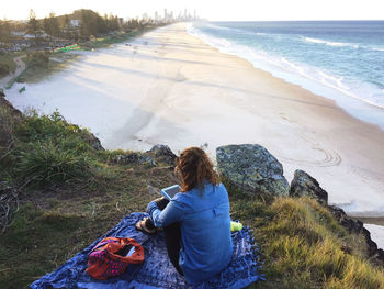 Rear view of woman looking at sea shore