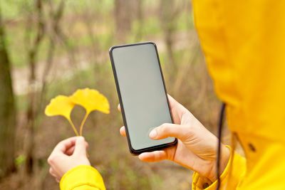 Midsection of woman using mobile phone