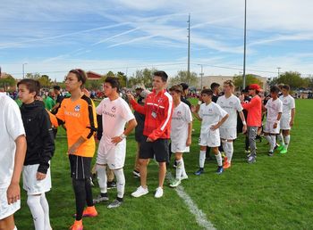 Panoramic view of people standing on field against sky
