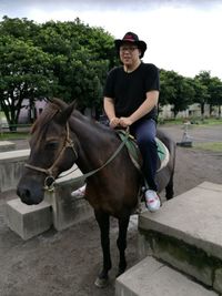 Portrait of man riding horse