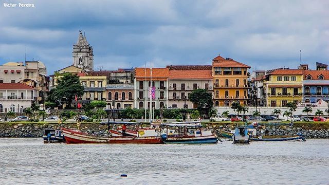 building exterior, architecture, built structure, nautical vessel, water, transportation, mode of transport, boat, waterfront, sky, moored, city, canal, cloud - sky, river, incidental people, travel, residential building, residential structure, cloud