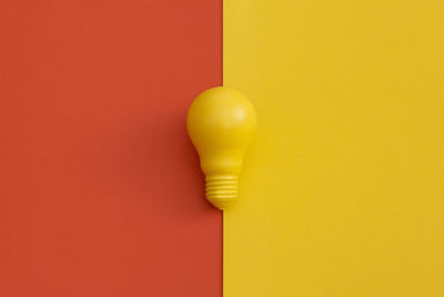 Close-up of yellow lamp against wall