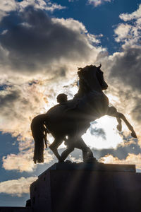 Low angle view of statue against sky during sunset