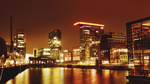 Reflection of buildings in water at night