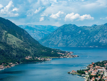 Scenic view of river and mountains against cloudy sky