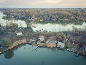 High angle view of lake by trees against sky