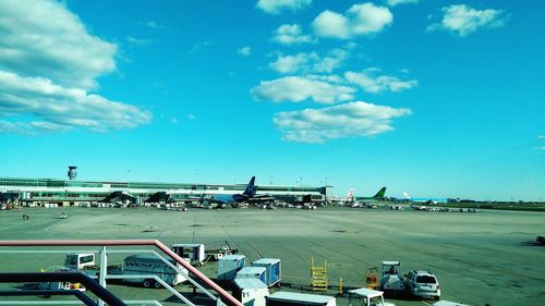 Airplane on airport runway against sky