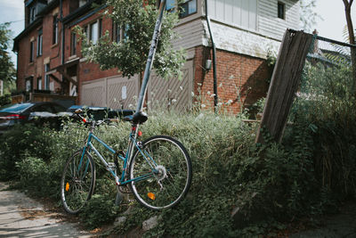 Bicycle parked outside house in yard