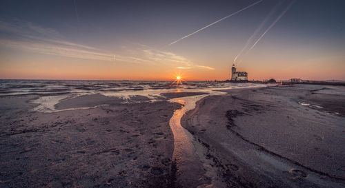 Scenic view of beach against sky during sunset