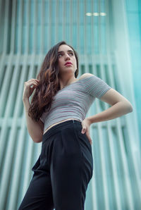 Beautiful woman standing against wall