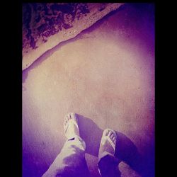 Low section of woman standing on tiled floor