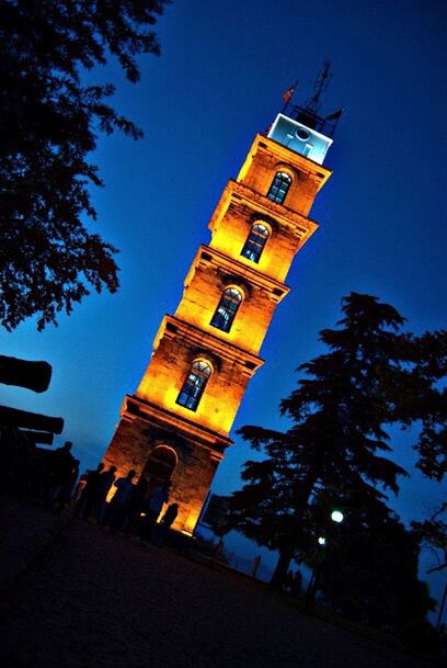 architecture, low angle view, built structure, building exterior, clear sky, tower, tree, tall - high, history, blue, clock tower, famous place, travel destinations, travel, sky, religion, tourism, outdoors, city