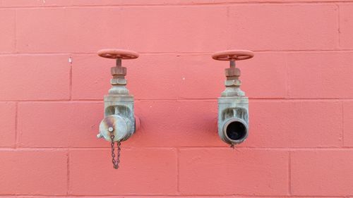 Close-up of water pipe against brick wall