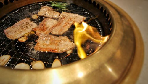 High angle view of meat on barbecue grill