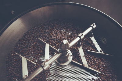 High angle view of roasted coffee beans in machinery