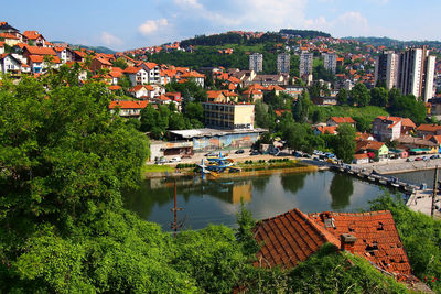 High angle view of houses in town against sky