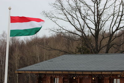 Low angle view of flag against built structure