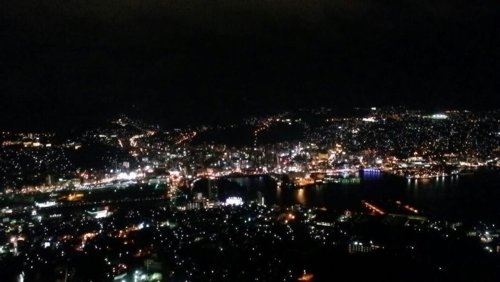 illuminated, night, cityscape, city, crowded, architecture, built structure, high angle view, aerial view, building exterior, water, river, residential district, city life, sky, copy space, clear sky, residential building, outdoors, residential structure