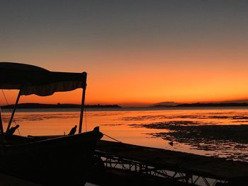 Scenic view of sea against orange sky