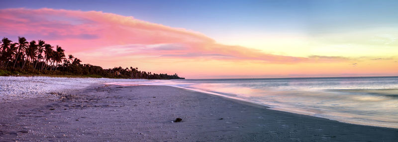 Scenic view of beach against sky during sunset