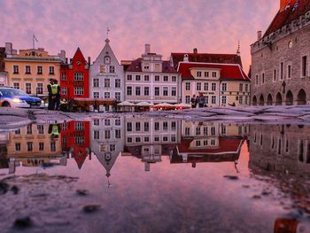 Reflection of buildings in puddle