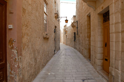 Narrow street amidst buildings