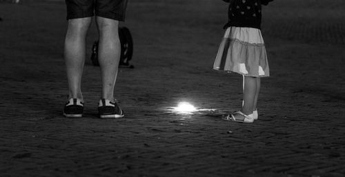 Low section of people standing on street