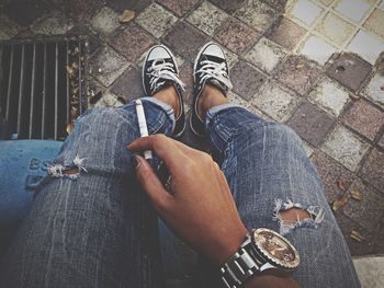 Low section of woman sitting on tiled floor